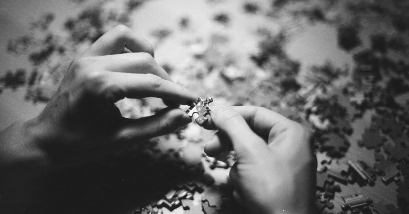 grayscale photo of person holding flower