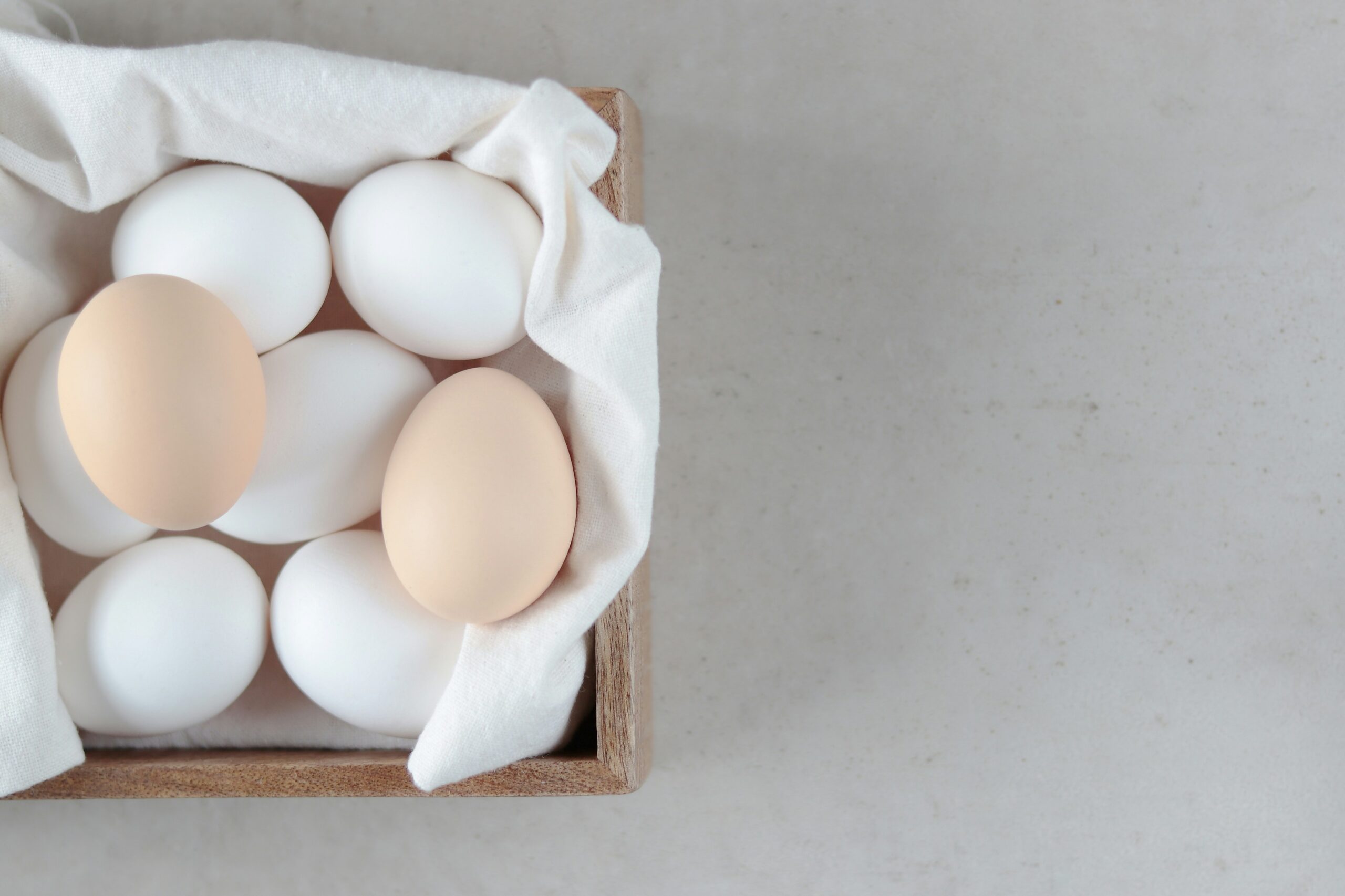 a wooden box filled with eggs on top of a table