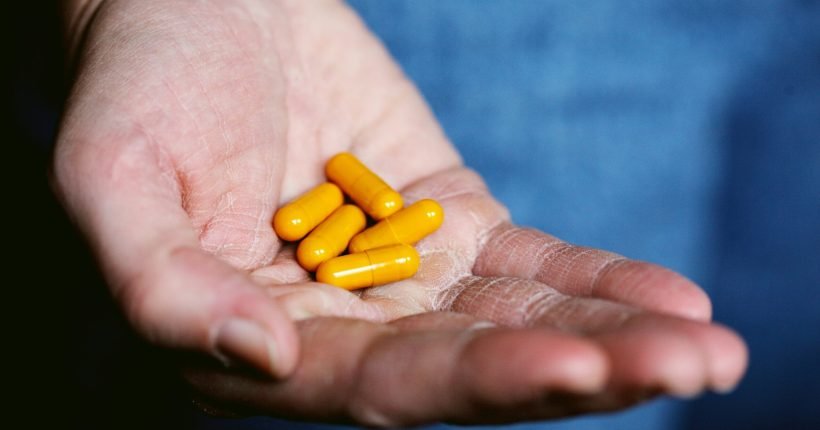 yellow medication pill - terbutalina - on persons hand