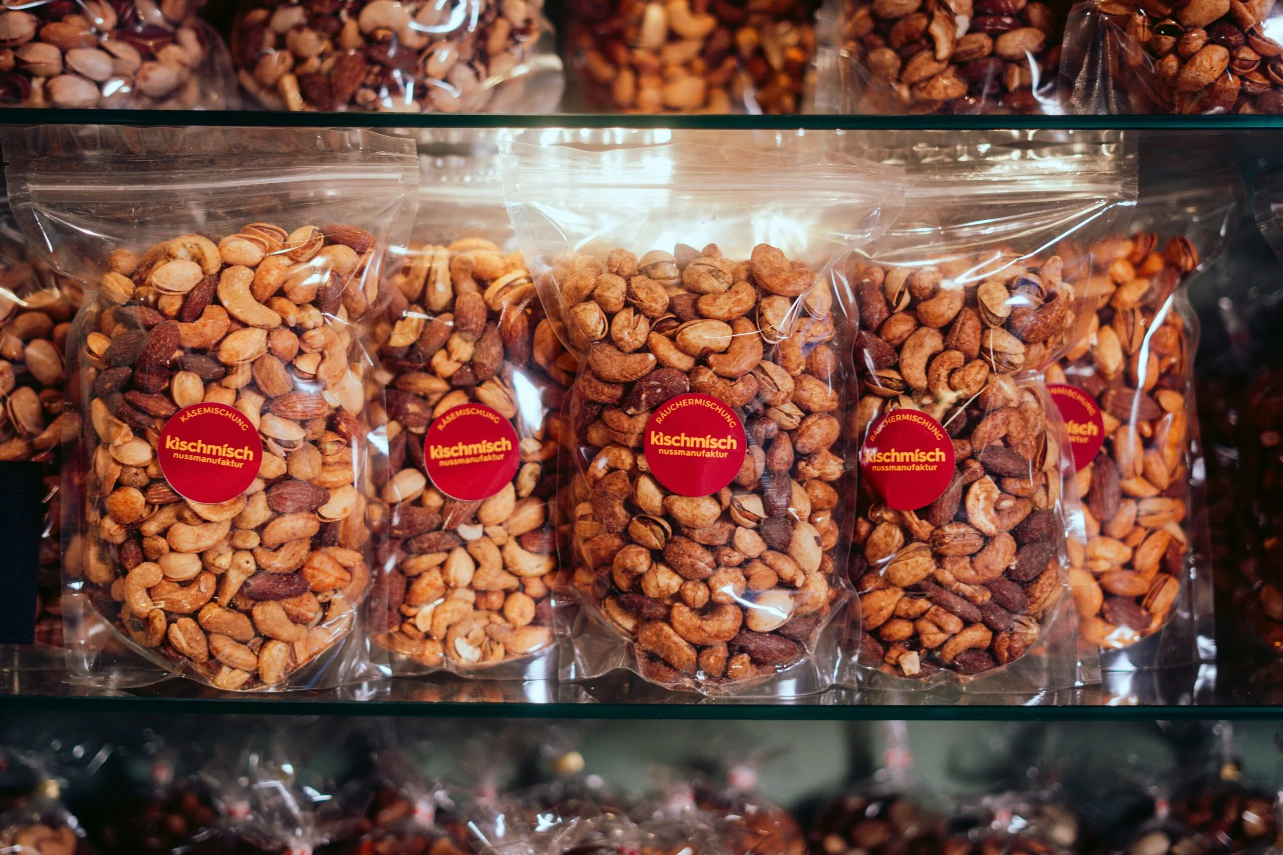 A display case filled with lots of chocolate covered nuts - pistache